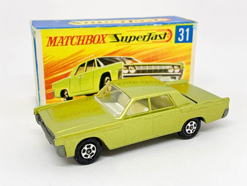 Matchbox Superfast 31c Lincoln Continental (Superfast 31a) - metallic lime green body with low arches, clear windows held by punched rivet, ivory interior, bare metal base, small diameter solid 5-spoke narrow wheels - Near Mint with usual small factory assembly mark below rear window in Near Mint "New" type G box with "TM" and matching model artwork.