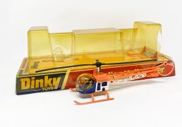 Dinky No.732 Bell "Police" Helicopter - white, orange, blue, with accessories, Mint model, including carded bases, the bubble is in average condition (discolored) as well as damage to one end and missing tab at the other. Sold as seen.