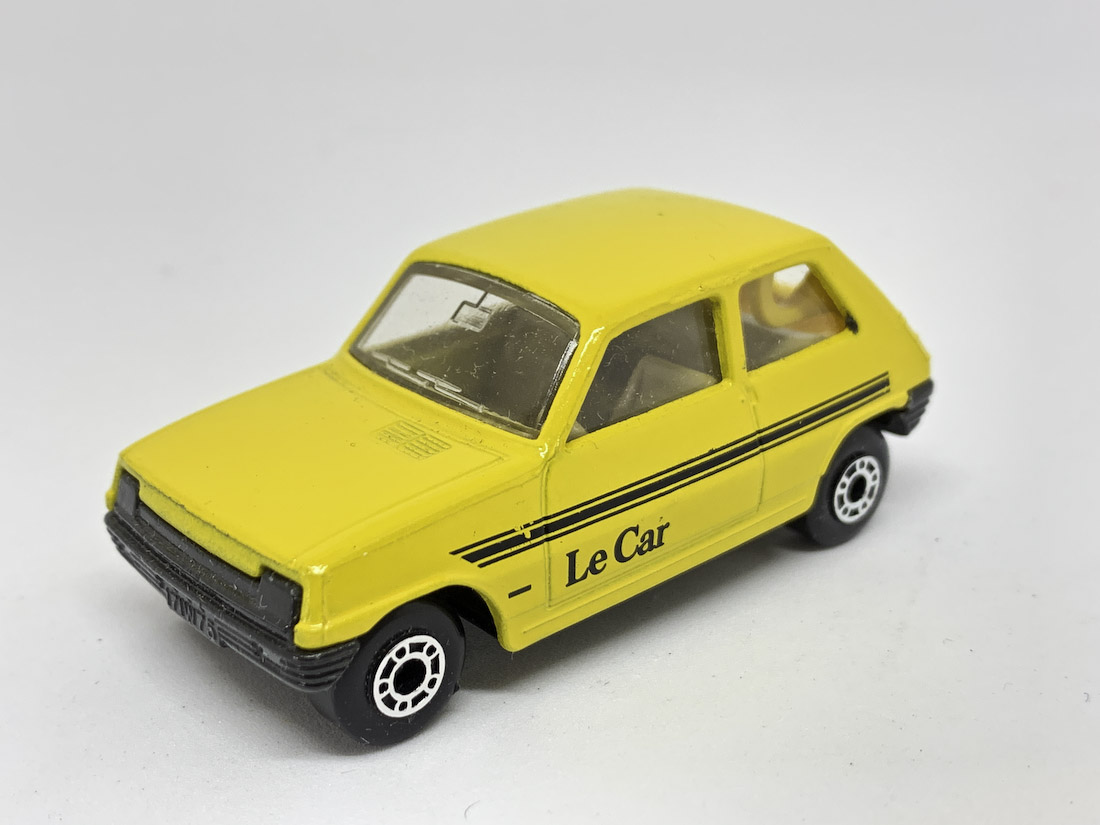 Matchbox Superfast No.21c Renault 5 TL - clear windows, dot-dash wheels, yellow body with black "Le Car" tampo print, tan interior, satin black base. Very near mint, unboxed.